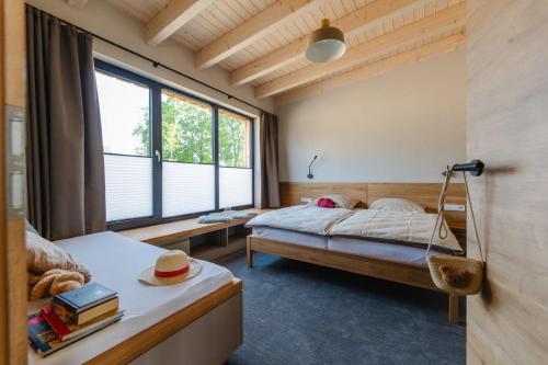 a bedroom with a bed and a large window at Birkenhof - Ferienhof, Landcafe und Rösterei in Schmallenberg