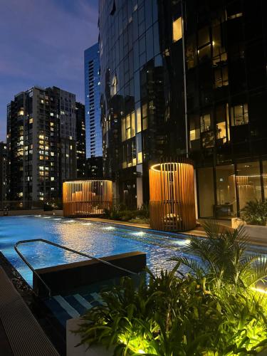 a swimming pool in the middle of a city at night at Skyline Serenity Retreat in Melbourne