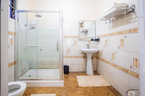 a bathroom with a shower and a toilet and a sink at O'wErisa Homes in Kampala