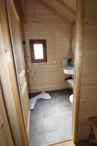 an inside view of a wooden cabin with a window at La cabane au bain perché in Aspach