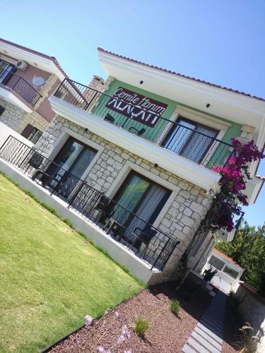 a building with a sign on the side of it at Cemile Hanım Konağı in Cesme