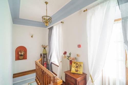 a staircase in a home with white curtains at Palladio Hotel - Portaria in Portaria