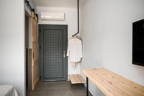 a room with a door and a wooden table at Gefiri Plakas Hotel, Tzoumerka in Plaka