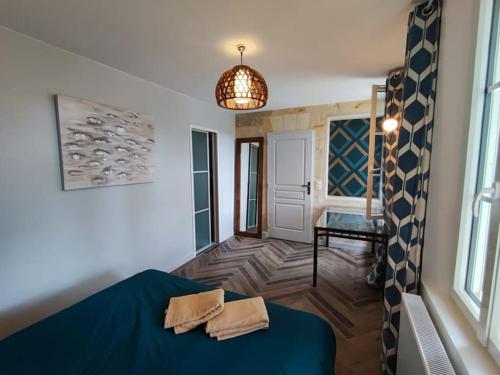 a bedroom with a blue bed in a room at Grande maison au calme in Saint-André-de-Cubzac