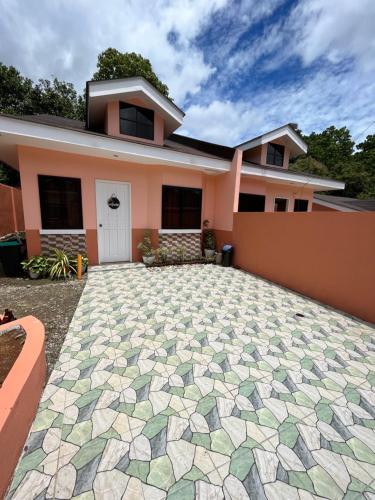 a house with a stone driveway in front of it at Wyll's House in Dipolog