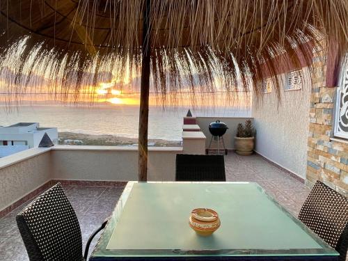 a table in a room with a view of the ocean at Master Suite in Bellavista Andalucia with Pool and Beach in Al Matlīn