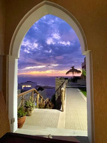 an archway leading to a balcony with a view of the ocean at Master Suite in Bellavista Andalucia with Pool and Beach in Al Matlīn