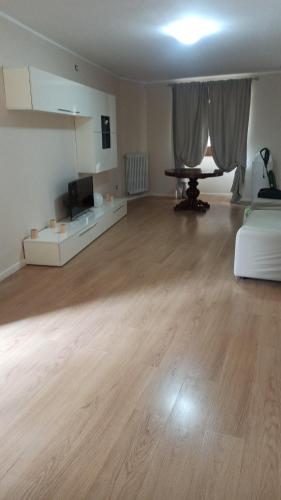 an empty living room with a table and a couch at Casa D&C in Avigliano