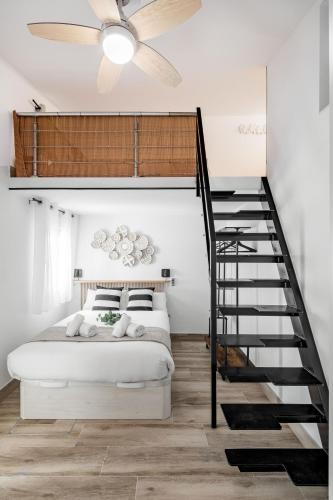 a bedroom with a loft bed and a staircase at Madrid Villaverde - Apartamentos acogedores, AC in Madrid
