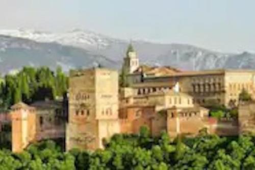 a large building with a tower on top of it at Evaleta 2, precioso apartamento recién estrenado in Monachil