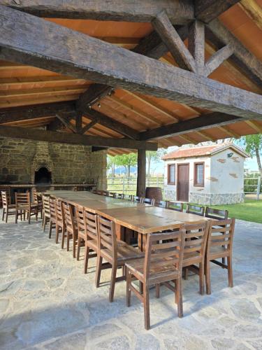 a large wooden table and chairs on a patio at Finca La Calancha in Cuerva
