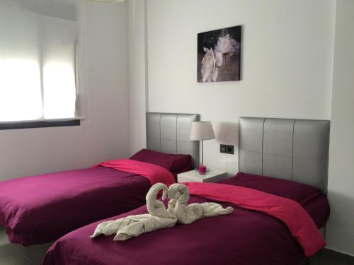 En eller flere senge i et værelse på Apartment OasisBeach La Zenia