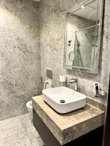 a bathroom with a sink and a toilet at Al Safwa One in Al Ḩadd