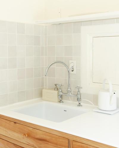 a bathroom with a sink and a mirror at Soomhouse in Danyang