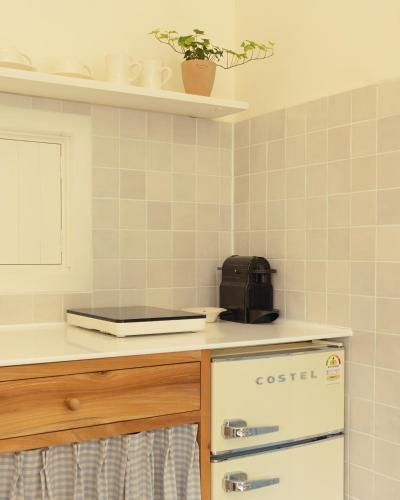 a kitchen with a stove and a counter top at Soomhouse in Danyang