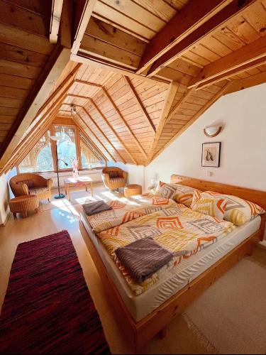 a large bedroom with a large bed in a house at Reichelhausen Vendégház in Kiskunhalas