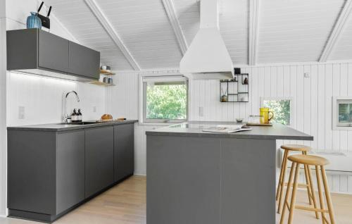 a kitchen with black and white counters and a sink at Beautiful Home In Odder With Wifi in Odder