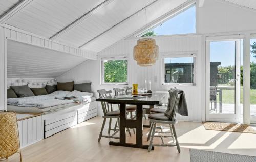 a kitchen with a table and chairs and a bed at Beautiful Home In Odder With Wifi in Odder