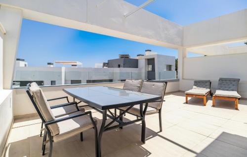 a table and chairs on a balcony with a view at Nice Apartment In Estepona With Wifi in Estepona