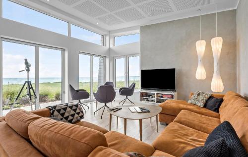 a living room with a couch and a television at Cozy Home In Kalundborg With Kitchen in Kalundborg