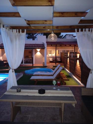 a villa with a swimming pool at night at Villa Red Porto Cheli in Porto Heli