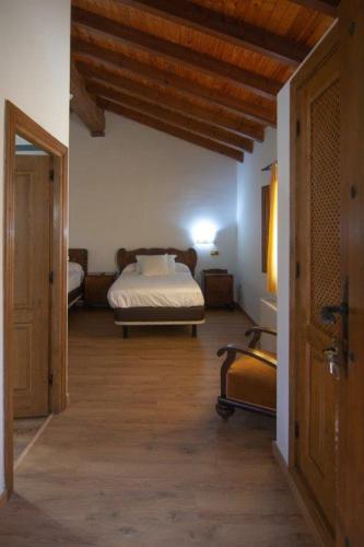 a bedroom with a bed in the middle of a room at Hospedium Hotel Rural Abadía de Yuste in Cuacos de Yuste