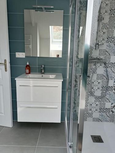 a bathroom with a sink and a shower at Gite les 3 Petiots in Pirou