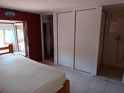 a bedroom with white closets and a bed in a room at Marie in Litochoro