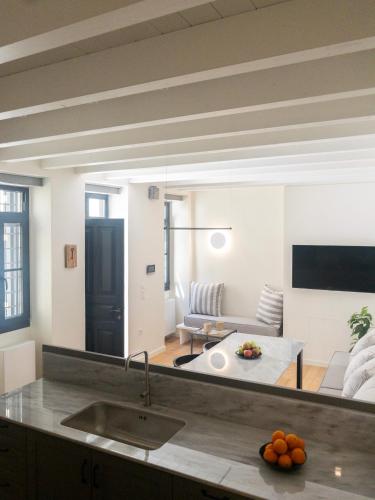 a kitchen and living room with a couch and a table at Bigtrel Athens in Athens