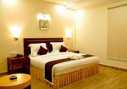 a bedroom with a large bed in a hotel room at The Ved Mantra in Gwalior