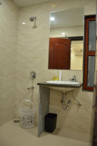 a bathroom with a sink and a mirror at The Ved Mantra in Gwalior