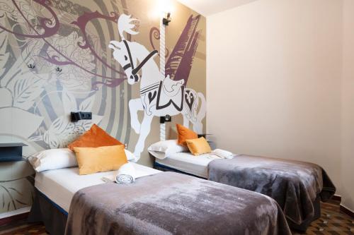 a room with two beds and a mural of a deer at Home Youth Hostel by Feetup Hostels in Valencia