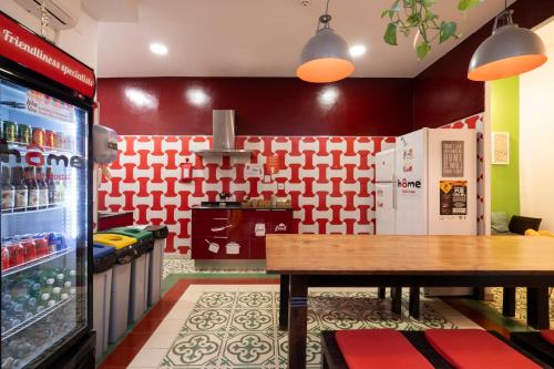 a fast food restaurant with a table and a refrigerator at Home Youth Hostel by Feetup Hostels in Valencia