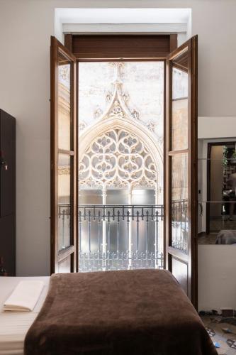 a bedroom with a large window and a bed at Home Youth Hostel by Feetup Hostels in Valencia