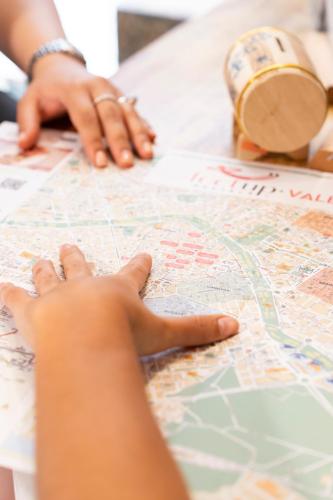 a person looking at a map on a table at Home Youth Hostel by Feetup Hostels in Valencia