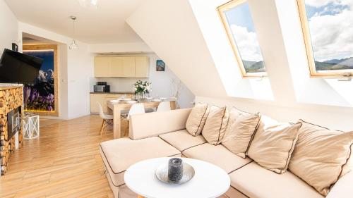a living room with a couch and a table at Aparthotel Delta Boutique in Kościelisko