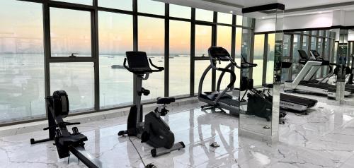 a gym with treadmills and exercise bikes in a building at Al Safwa One in Al Ḩadd