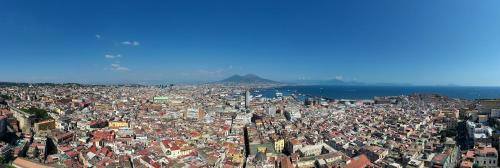 an aerial view of a city with a mountain in the background at San Francesco al Monte in Naples