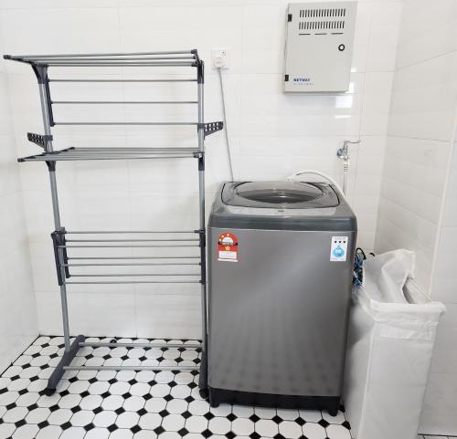 a trash can in a bathroom with a black and white floor at Ayera Residence Muji X Near Permas X Staycation 4BR4B #12 pax by Cowidea in Masai
