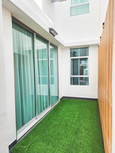 an empty balcony with green grass in a house at Ayera Residence Muji X Near Permas X Staycation 4BR4B #12 pax by Cowidea in Masai