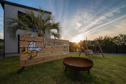 a playground with a wooden bench and a swing at PrivateVilla8 in Minamiawaji
