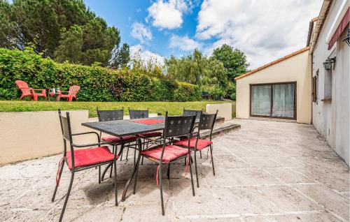 une table et des chaises assises sur une terrasse dans l'établissement 4 Bedroom Gorgeous Home In Bouguenais, à Bouguenais