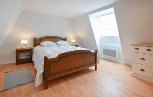 a bedroom with a large bed and a window at 3 Bedroom Beautiful Home In Lessay in Lessay