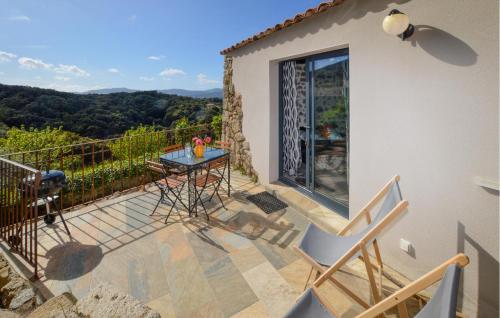 un patio avec une table et des chaises sur un balcon dans l'établissement Beautiful Home In Petreto Bicchisano, à Petreto-Bicchisano