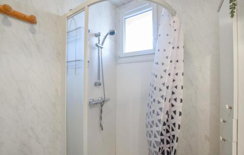 a shower in a bathroom with a window at 3 Bedroom Beautiful Home In Lessay in Lessay