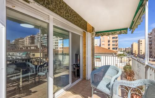 a balcony with two chairs and a view of a city at 3 Bedroom Nice Apartment In Santa Pola in Santa Pola
