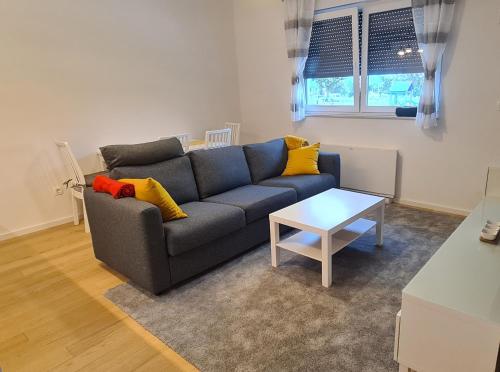 a living room with a couch and a table at RingPeace Apartment, Dubrava - free parking in Zagreb