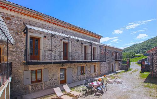 a building with a patio with a table and chairs at Pet Friendly Home In Privas With Sauna in Privas