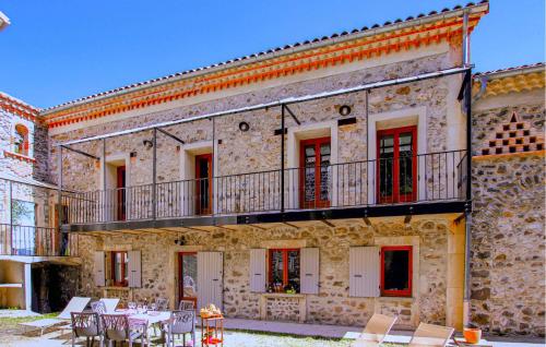 an old stone building with tables and chairs at Pet Friendly Home In Privas With Sauna in Privas