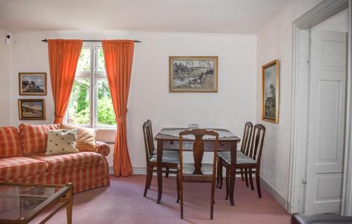 a living room with a table and a couch at Cozy Home In Mörrum With Wifi in Mörrum